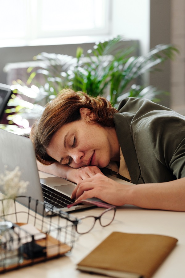 sleeping woman laptop desk glasses during daytime